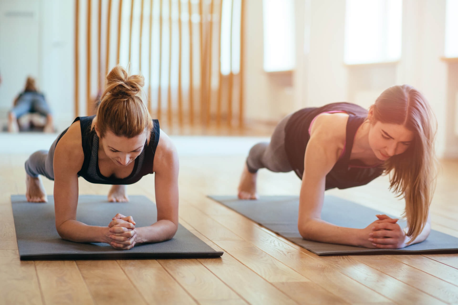 Women in plank pose in a fitness class setting