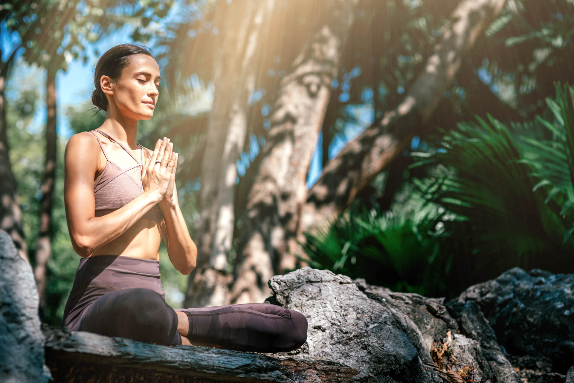 Women in meditation surrounded by nature