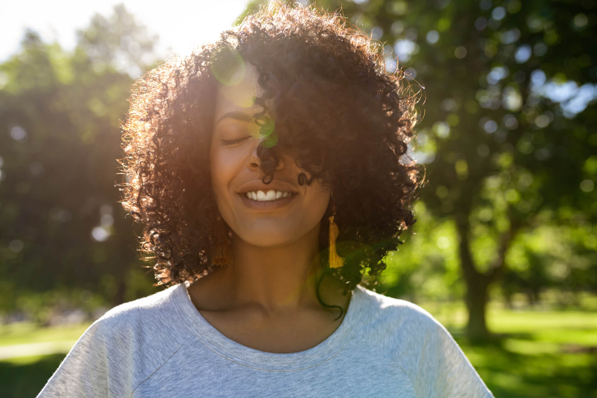 Happy woman in the sun with a healthy mindset